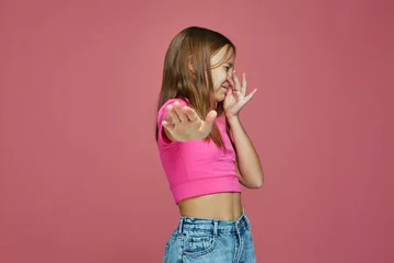 Foto op Canvas Bad smell. Child girl pinch nose showing stop gesture, feel disgust on pink studio background. Toxic hideous odor © Georgii