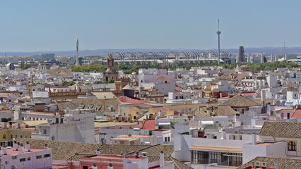 Aerial view on downtown seville, Spain, with typical white painted houses churches and arch structure and radio tower of expo 92 in the background 