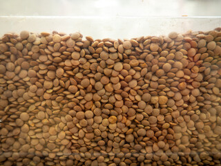 Red lentils. Grains background. In the store on the showcase.