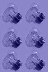 light bulb pattern on a lilac  background. Toned in trendy Very Peri color of the Year 2022