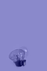 light bulb pattern on a lilac  background. Toned in trendy Very Peri color of the Year 2022