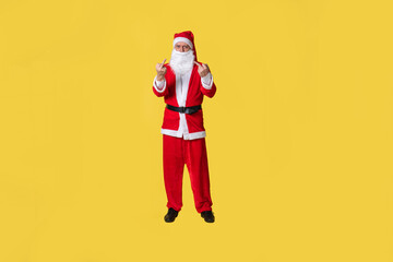 Fototapeta na wymiar Santa claus yellow fat tradition background december people. Grandpa's eve time middle finger