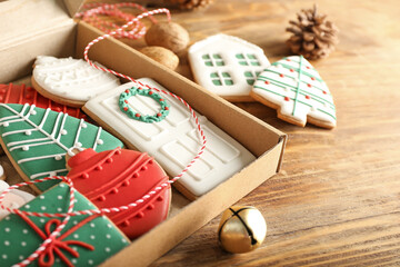 Box with beautiful Christmas cookies on wooden background