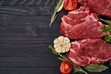 meat on wooden board vegetables and ingredients for cooking wooden background