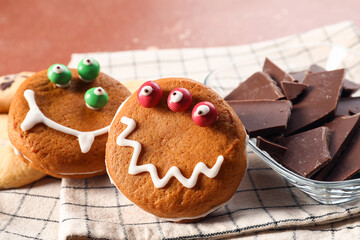 Funny cookies with chocolate on color background