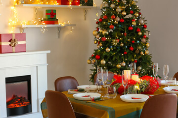 Dining table with beautiful setting in living room decorated for Christmas eve