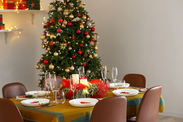 Dining table with beautiful setting in living room decorated for Christmas eve