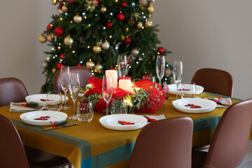 Dining table with beautiful setting in living room decorated for Christmas eve