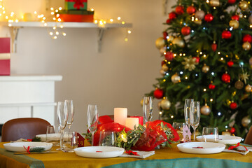 Dining table with beautiful setting in living room decorated for Christmas eve