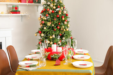 Dining table with beautiful setting in living room decorated for Christmas eve