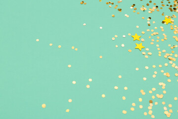 Beautiful golden confetti on color background