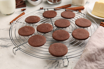 Grid with tasty chocolate cookies on white marble background