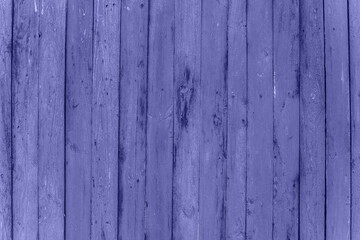 Obraz premium Trendy Color of Year. Very peri. 2022. fence made of wood. Wooden background with weathered wood.