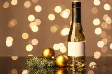 Bottle of champagne and Christmas decor on table against blurred background