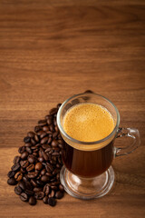 Espresso and coffee beans on the table.