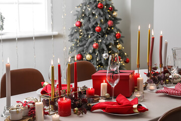 Beautiful Christmas table setting with decor in room interior