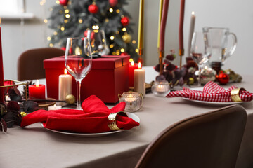 Dining table with beautiful setting for Christmas celebration in room