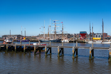 Fototapeta premium Walking on beach of Harlingen fisherman town on Wadden sea, Friesland, Netherlands at low tide