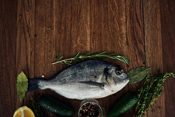sea fish fresh ingredients lemon on wooden board