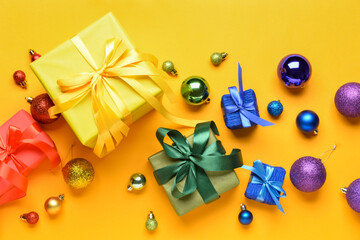 Christmas gifts and decor on color background. LGBT concept