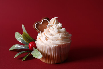 Delicious Christmas cupcake on red background