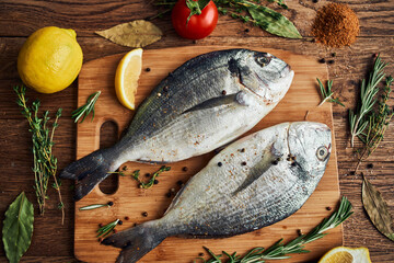 sea fish fresh ingredients lemon on wooden board