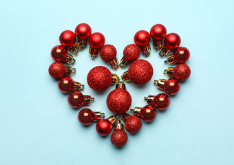 Heart made of Christmas balls on blue background