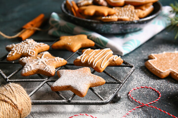 Grid with sweet Christmas gingerbread cookies on black background, closeup
