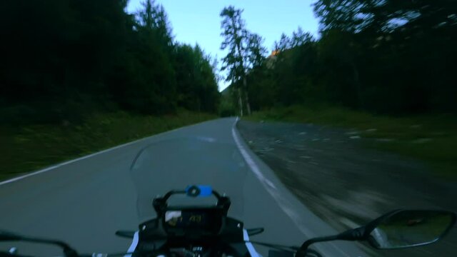 Riding a motorcycle on a scenic mountain road in the morning at sunrise, to the Sanetsch pass in Switzerland