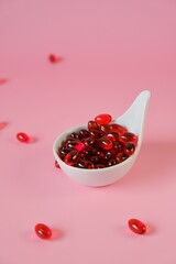 Krill oil capsules in a ceramic spoon .Natural supplements and vitamin.omega fatty acids.Healthy eating and food supplements 