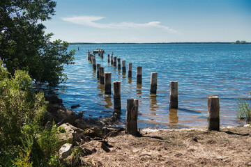Fototapeta premium remains of the pier and pillars in the ocean water
