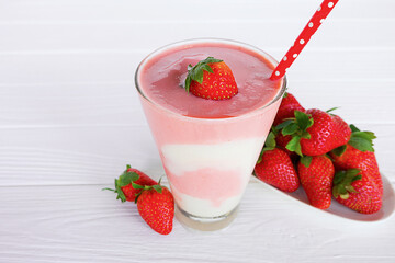 Strawberry yogurt fruit juice smoothie pink colorful fruit juice milkshake blend beverage healthy high protein the taste yummy In glass drink episode morning on white wood background.