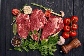 meat on wooden board vegetables and ingredients for cooking wooden background