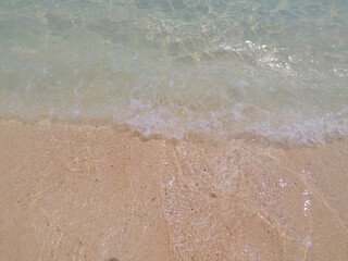Background photo of clear sea water and waves on the beach