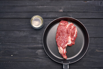 meat steak in a frying pan food ingredients kitchen wooden table