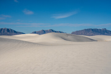 Fototapeta na wymiar Smooth Undulating Dunes And Jagged San Andres Mountains