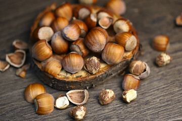 Selective focus. Hazelnuts, peeled and peeled on a wooden surface.