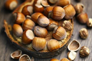 Selective focus. Hazelnuts, peeled and peeled on a wooden surface.