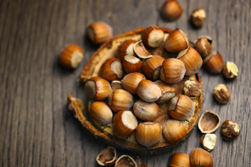 Selective focus. Hazelnuts, peeled and peeled on a wooden surface.