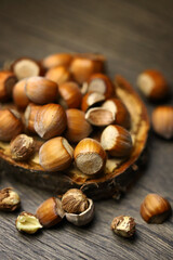Selective focus. Hazelnuts, peeled and peeled on a wooden surface.