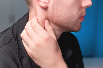 Naklejka premium Young Caucasian male masseur doing self-neck massage to himself. Close-up. Myofasceal release