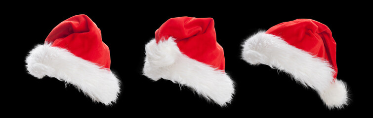 Obraz na płótnie Canvas Set of Santa hats. Isolated on black background.