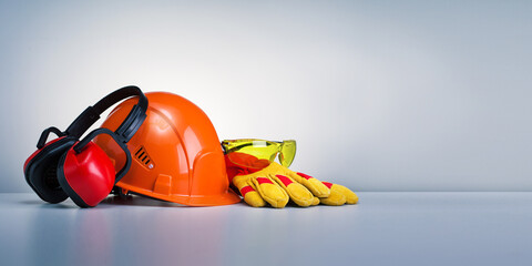Work safety protection equipment on grey background with copy space. Horizontal banner. - Powered by Adobe