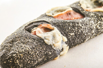 Squid ink cheese bread on a white background