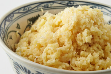 Close-up of fresh minced garlic in a bowl