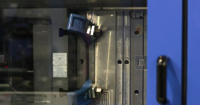 Production Of Plastic Parts In A Factory With Automatic Injection Molding Machine. close up