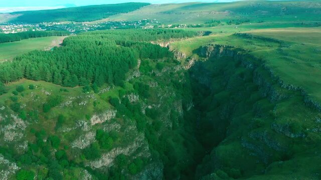 Canyon in the mountains with a river and trees, shooting from the gorse