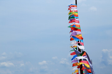 Colorful fabric flags againt the sky.