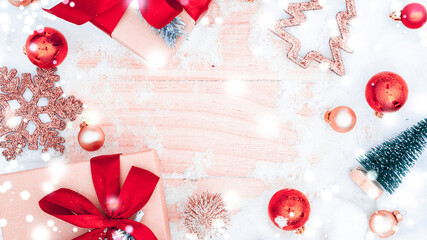 Xmas background table. Winter wooden decoration backdrop. Christmas board with old rustic wall, white frozen snow, golden balls and gift box. Minimal flat lay.