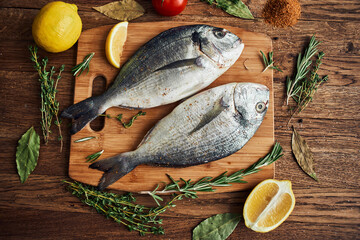 sea fish fresh ingredients lemon on wooden board